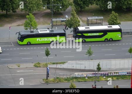 Berlin, Germany - 23 May 25: High angle view from Berliner Fernsehturm of two long distance coaches at a roadside stop beside trees in Berlin, Germany Stock Photo