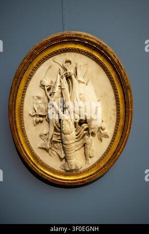 Berlin, Germany - 23 May 25: Oval marble relief with fish, lobster and hanging game motif displayed at the Bode Museum in Berlin, Germany. Stock Photo