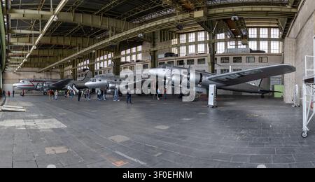 Berlin, Germany - 23 May 25: Panoramic view of multiple historic airplanes displayed inside the large hangar at Tempelhof Airport in Berlin, Germany. Stock Photo