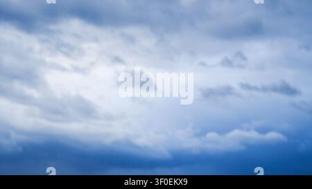 Softly blurred view of blue and white cloudy sky at daylight Stock Photo