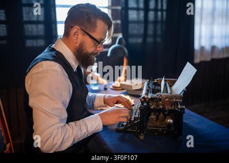 Close view of a man typing on a vintage typewriter Stock Photo