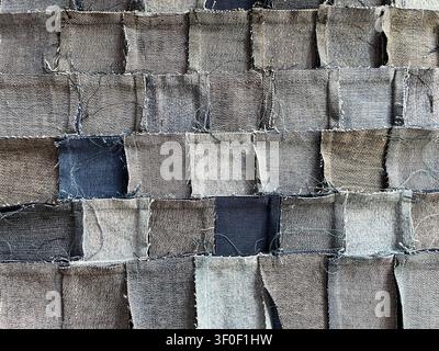 Close-up of the back of a handmade denim patchwork fabric woven from recycled jeans pieces, perfect for textile and upcycling themes Stock Photo