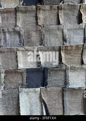 Close-up of the back of a handmade denim patchwork fabric woven from recycled jeans pieces, perfect for textile and upcycling themes Stock Photo