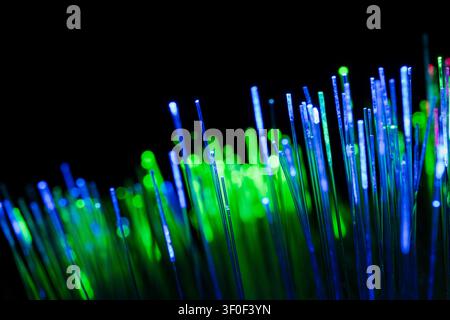 Close-up motion of glowing fiber optic strands symbolizing high-speed data transmission and digital connectivity. Stock Photo