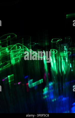 Dynamic neon green and cyan light streams forming an abstract digital landscape. Perfect for big data, cloud computing, virtual technolog Stock Photo