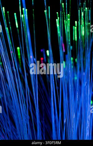 Blue fiber optic light streaks flowing in motion with soft glowing particles. Clean and modern abstract background representing high-speed internet, d Stock Photo
