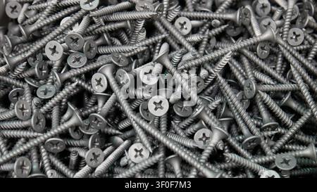 Close-up of a big pile of beautiful grey screws Stock Photo
