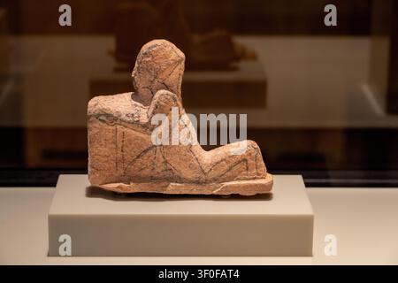 Berlin, Germany - 23 May 25: Museum photograph of a small seated ancient figure displayed at the Neues Museum in Berlin, Germany. Stock Photo