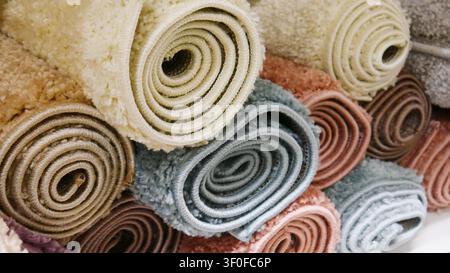 A pile of different soft colored carpets close-up Stock Photo