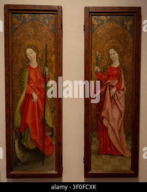 Wurzburg, Germany - 31 May 25: Late Gothic painted wooden panels with haloed female figures on display in the Lower Franconian Museum, Würzburg, Bavar Stock Photo