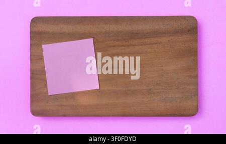 Pink Sticky Note on Wooden Board with Copy Space Stock Photo