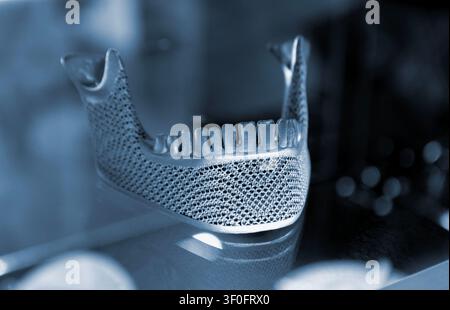 Object custom jaw printed on 3D printer from titanium. Model lower jaw printed 3D printer from metal powder. Selective Laser Melting. SLM. Additive new modern manufacturing. 3D printing technology Stock Photo