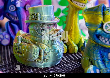 Different colorful toys printed on 3D printer. Art models printed on 3D printer from molten plastic. FDM technology. Fused Deposition Modeling. Additive modern manufacturing technology. 3D printing Stock Photo