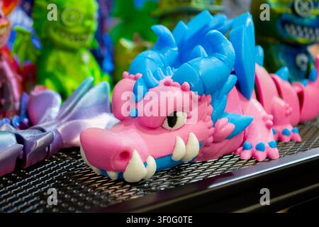 Different colorful toys printed on 3D printer. Art models printed on 3D printer from molten plastic. FDM technology. Fused Deposition Modeling. Additive modern manufacturing technology. 3D printing Stock Photo