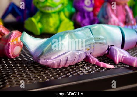 Colorful toy printed on 3D printer. Art purple model printed on 3D printer from molten plastic. FDM technology. Fused Deposition Modeling. Additive modern manufacturing technology. 3D printing Stock Photo