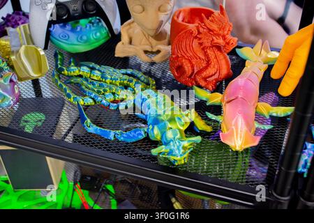 Different colorful toys printed on 3D printer. Art models printed on 3D printer from molten plastic. FDM technology. Fused Deposition Modeling. Additive modern manufacturing technology. 3D printing Stock Photo