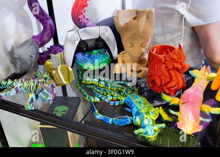 Different colorful toys printed on 3D printer. Art models printed on 3D printer from molten plastic. FDM technology. Fused Deposition Modeling. Additive modern manufacturing technology. 3D printing Stock Photo