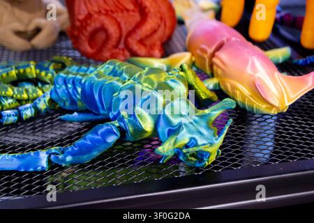 Colorful toy printed on 3D printer. Art multicolored model printed on 3D printer from molten plastic. FDM technology. Fused Deposition Modeling. Additive modern manufacturing technology. 3D printing Stock Photo