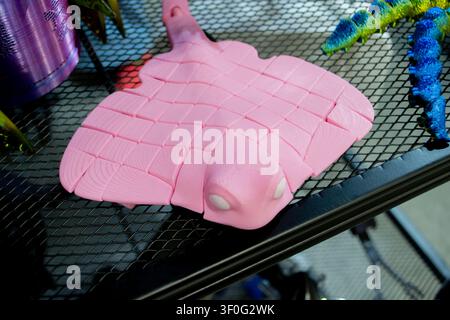 Colorful toy printed on 3D printer. Art pink model printed on 3D printer from molten plastic. FDM technology. Fused Deposition Modeling. Additive modern manufacturing technology. 3D printing Stock Photo