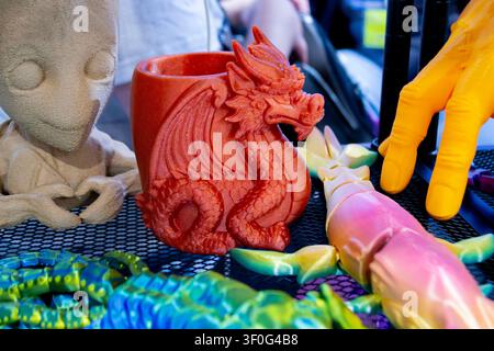 Colorful toy dragon printed on 3D printer. Art brown model printed on 3D printer from molten plastic. FDM technology. Fused Deposition Modeling. Additive modern manufacturing technology 3D printing Stock Photo