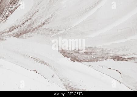 Horizontal macro top down shot of white texture paste brushstrokes applied to a brown primed artist canvas creating a minimalist abstract pattern on s Stock Photo