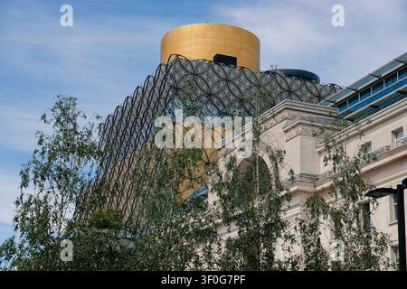 The Library of Birmingham and Baskerville House behind a modern glass structure in Centenary Square, UK Stock Photo