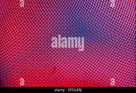 Metal mesh grid glowing red and blue in diamond pattern abstract close up Stock Photo