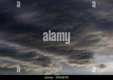 Dense cloud formation moving in diagonal bands with subtle contrast between dark and pale tones Stock Photo