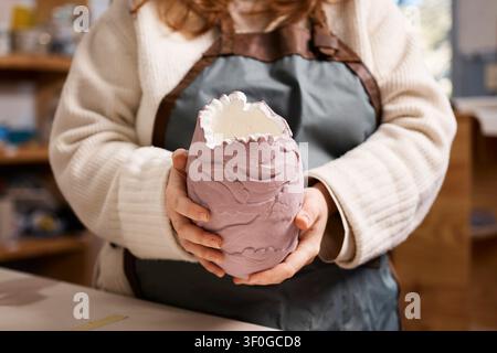 Pottery Artist Holding Handmade Ceramic Vase in Small Pottery Studio for Small Business Stock Photo