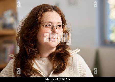 Pottery Studio Owner Portrait Looking Thoughtful in Cozy Workshop - Female Creative Small Business Artist Stock Photo