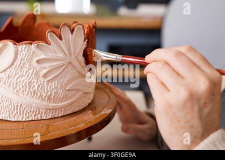 Pottery Artist Painting Decorative Ceramic Bowl in Pottery Studio Small Business Creative Owner Stock Photo