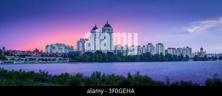 After sunset glow at cloudy sky over the Obolon district. Stock Photo