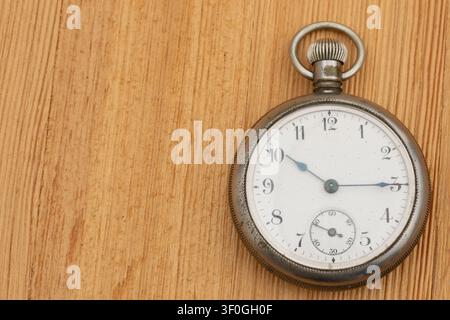 Vintage pocket watch on wood background for memories and passing of time Stock Photo