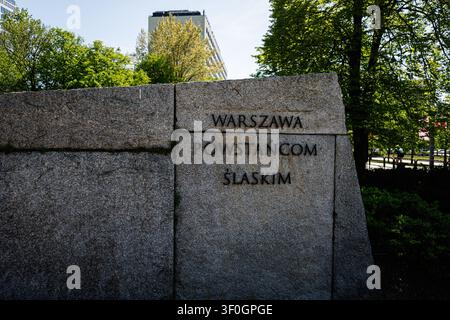 Stone memorial bearing the Warszawa Powstańcom Śląskim inscription set in a green park in Katowice, Poland. Stock Photo