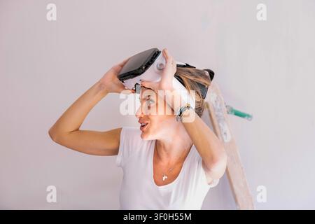 Woman using a vr headset to visualize interior design for a home renovation project Stock Photo