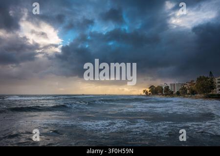 Powerful storm clouds gather over the churning Mediterranean Sea along the Limassol seafront in Cyprus. Stock Photo