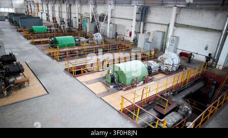 Interior of chemical enterprise shows high-pressure turbo compressors for supplying air separation units. Large mechanical facility powerful units for Stock Photo