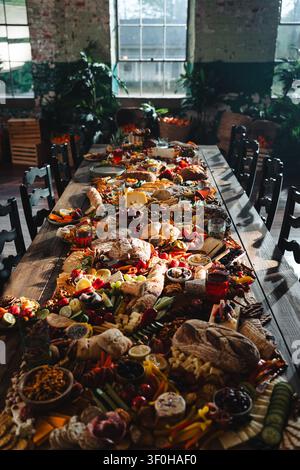 Large rustic grazing table with assorted food and bread Stock Photo