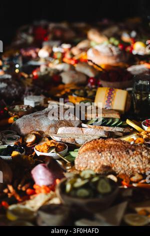Large rustic grazing board with assorted breads cheese and appetizers Stock Photo