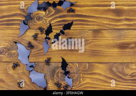 Halloween composition with spiders and bats on wooden background. Top view, copy space Stock Photo