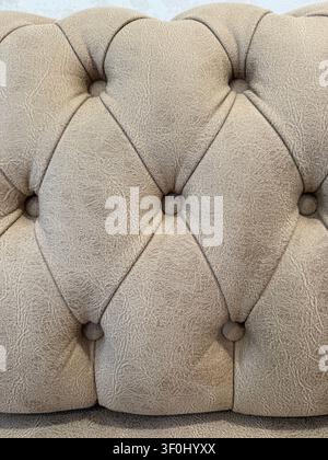 Brown tufted leather upholstery texture background with intricate stitching pattern. Mobile photo Stock Photo