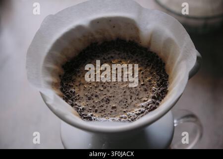 Close-up of manual coffee brewing with V60 dripper and paper filter Stock Photo