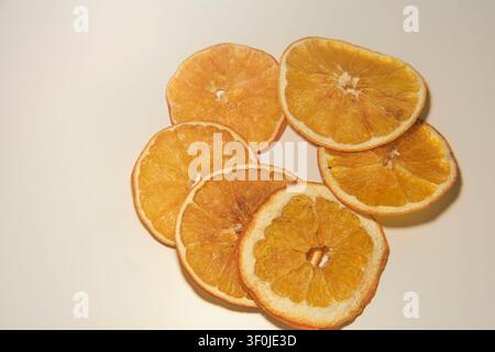 Dried orange slices arranged on white background close-up Stock Photo