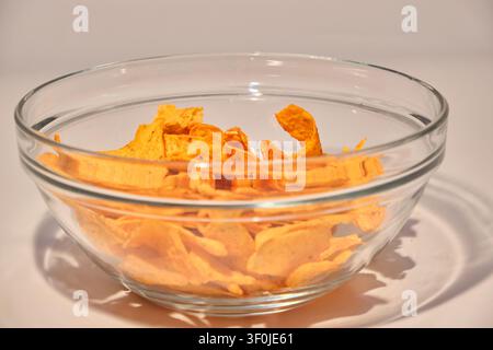 Crunchy seasoned tortilla corn chips with salsa sauce on white background close-up Stock Photo