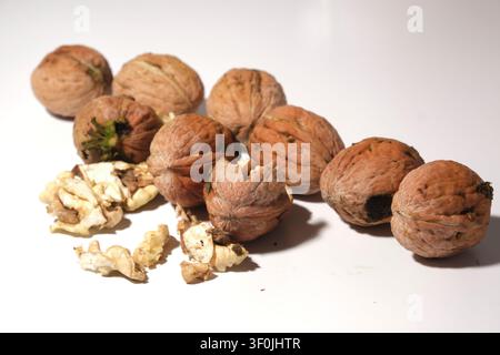 Close-up of whole walnuts with textured shells on a rustic wooden table Stock Photo