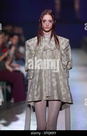 Berlin, Germany, 3rd Jul, 2026. Model wearing a plaid button-up shirt and black 3D floral rose shorts on the runway at the Kilian Kerner fashion show. Stock Photo