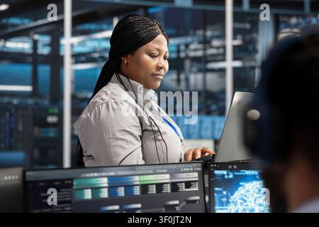 Server facility software engineer applying AI neural network models tech. Stock Photo