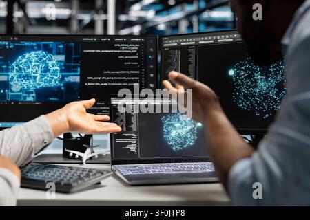 Data center engineering team reviews data analysis graph to reduce supercomputers failure. Stock Photo