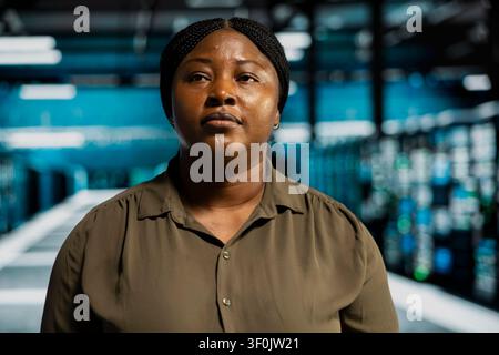 Technical specialist doing maintenance in server facility with setup helping companies stay connected. Stock Photo