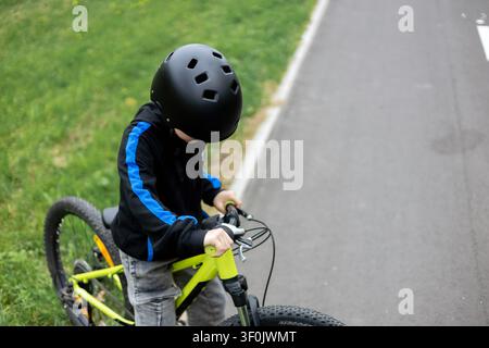 High Angle View of Boy on Neon Bicycle Stock Photo
